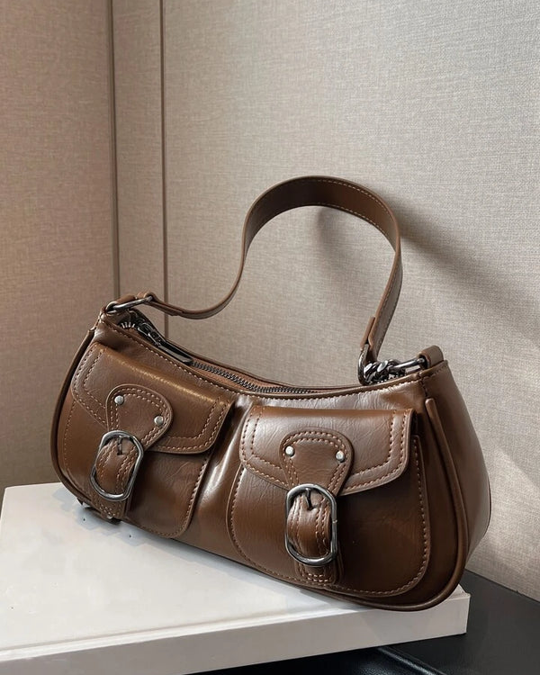 Coffee shoulder bag with front buckle pockets, silver hardware, and adjustable strap for everyday wear.