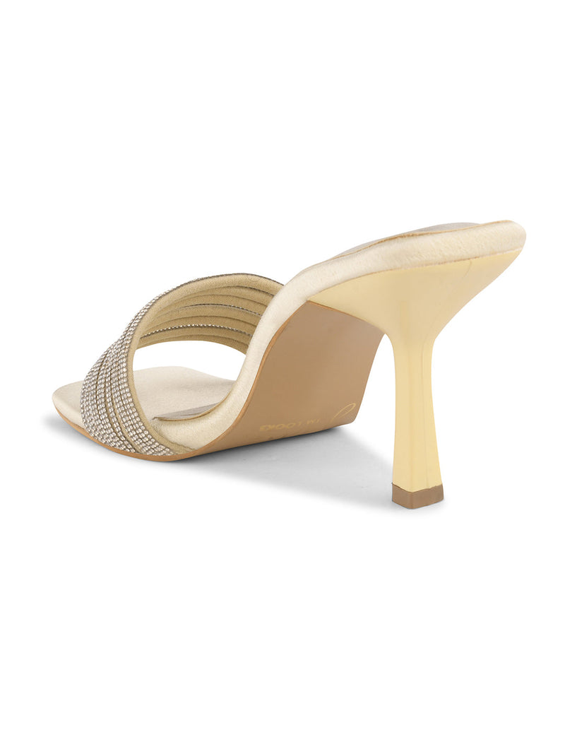 pen-toe high-heeled mules with an embellished wide strap and a contemporary square toe
 Gold