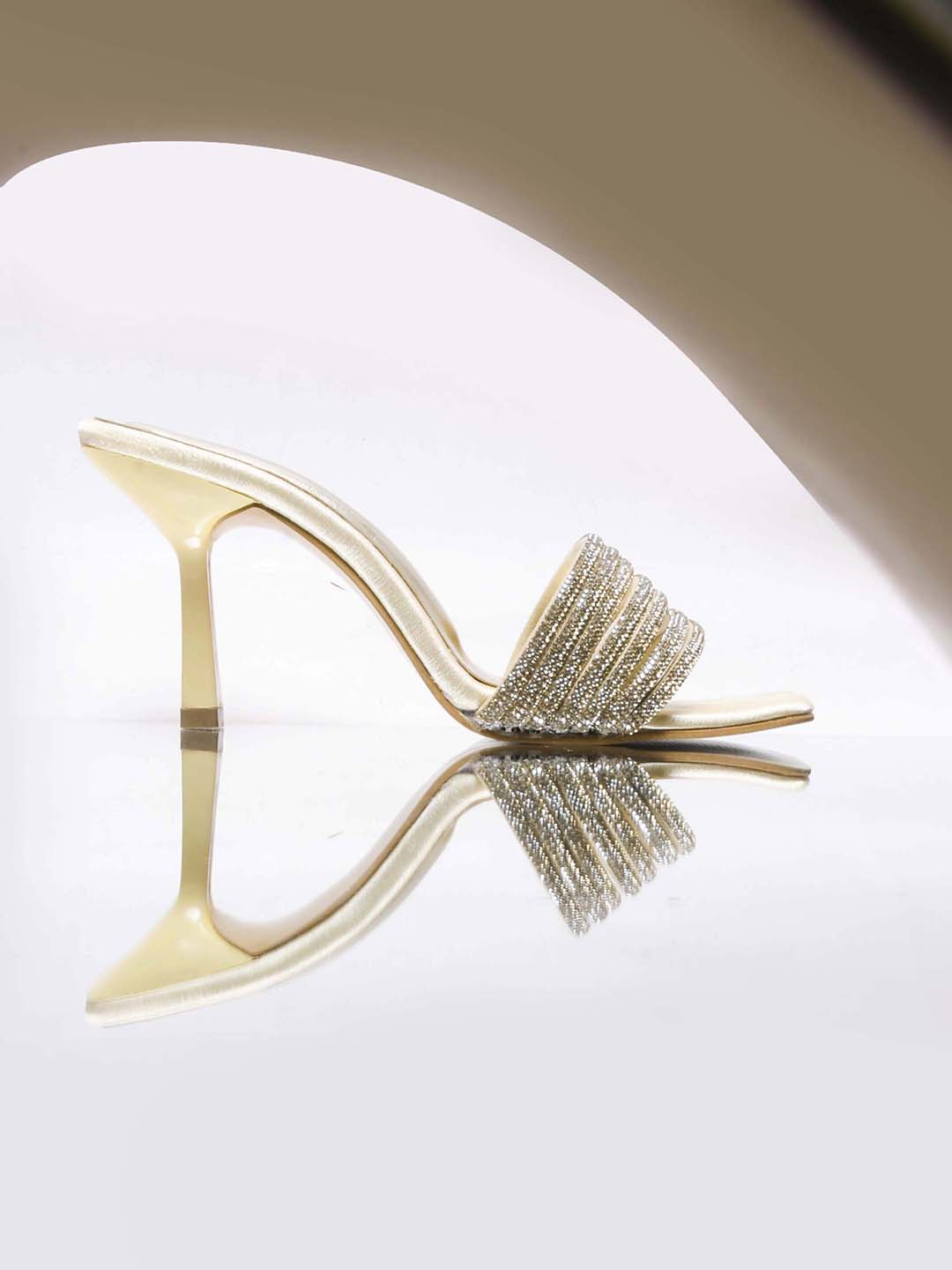 pen-toe high-heeled mules with an embellished wide strap and a contemporary square toe
 Gold