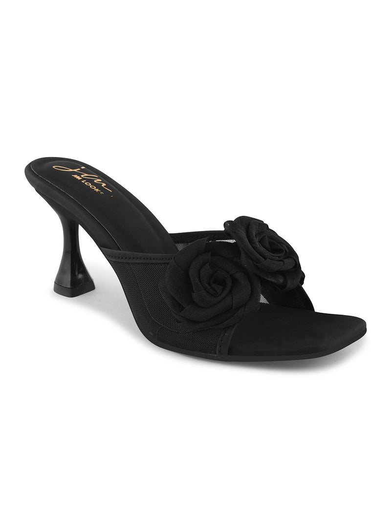 JM Looks heeled mules featuring two prominent floral appliques on the vamp strap and a flared heel
 Black