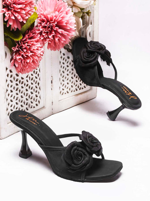 JM Looks heeled mules featuring two prominent floral appliques on the vamp strap and a flared heel
 Black