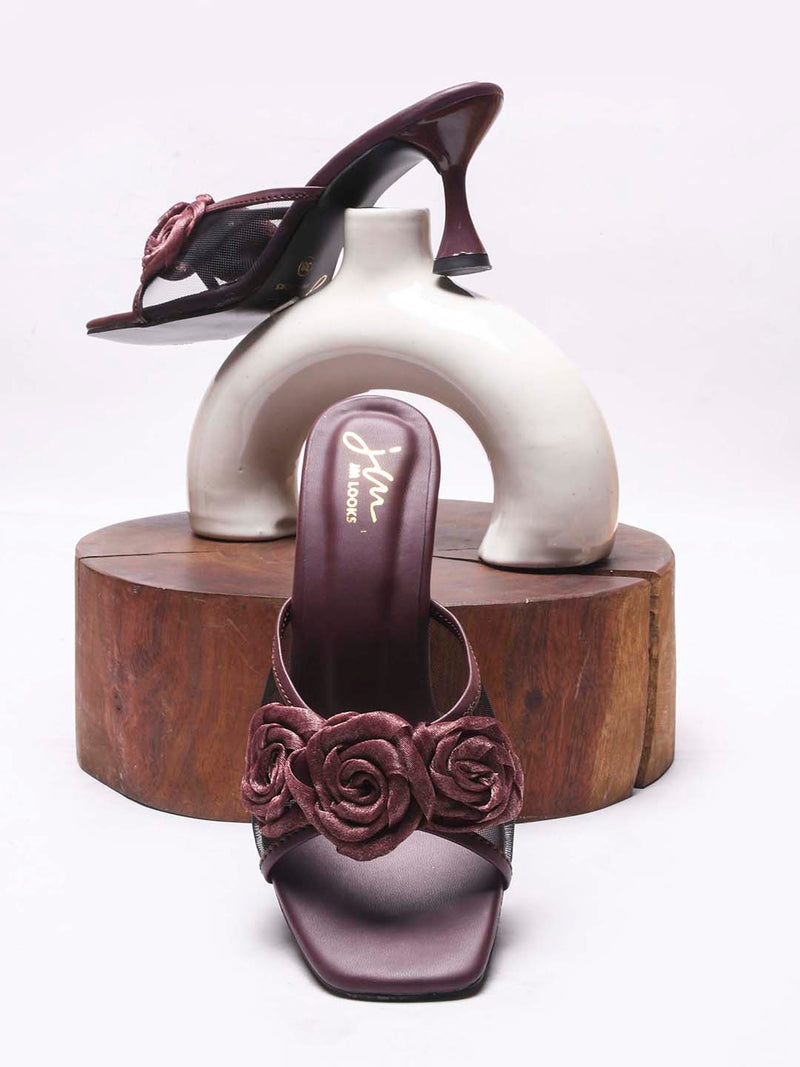 JM Looks heeled mules featuring two prominent floral appliques on the vamp strap and a flared heel
 Wine