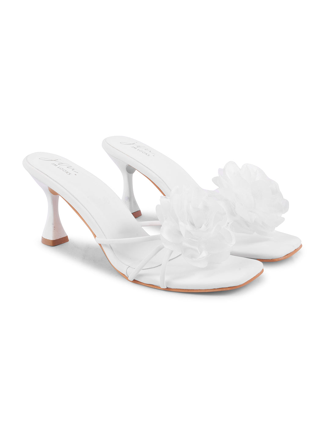 women's heeled mules featuring a large floral embellishment on the strap
 White