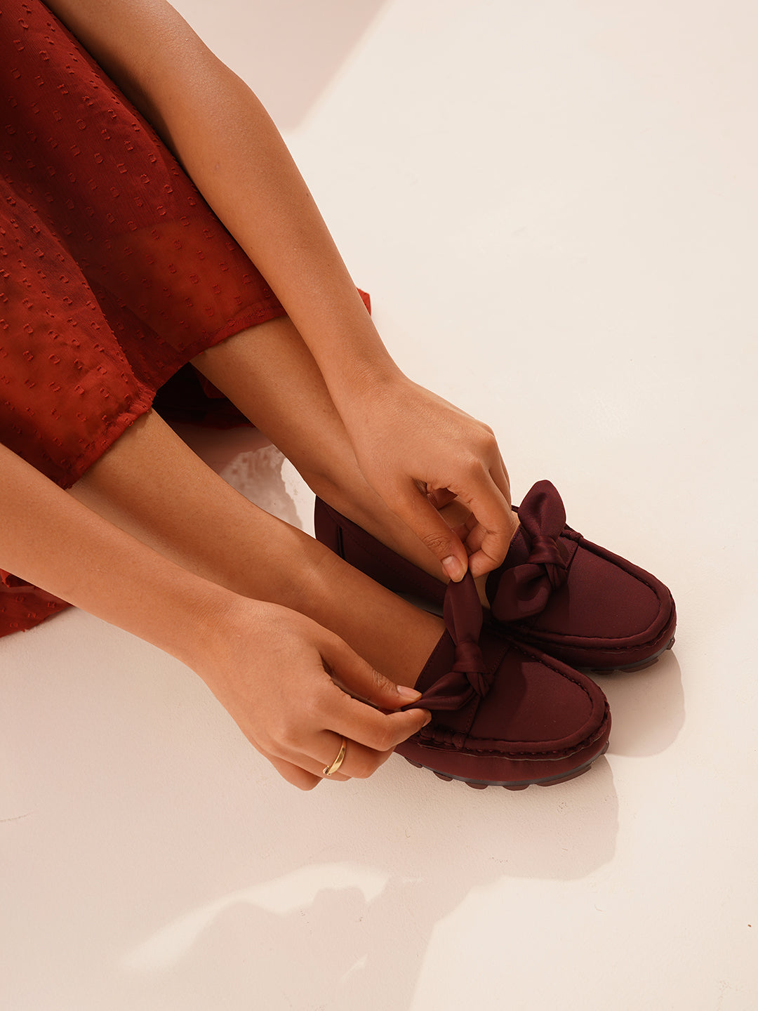 casual loafers with a prominent bow detail on the vamp
 Cherry