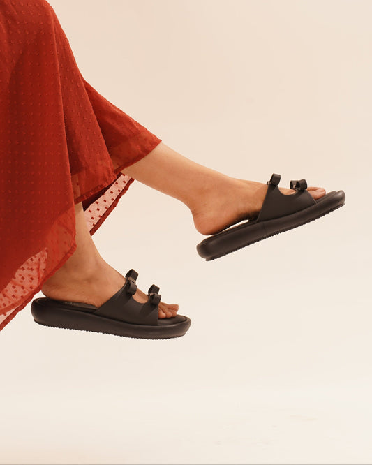 JM Looks slide sandals featuring multiple bow details on the wide straps and a flat sole
 Black