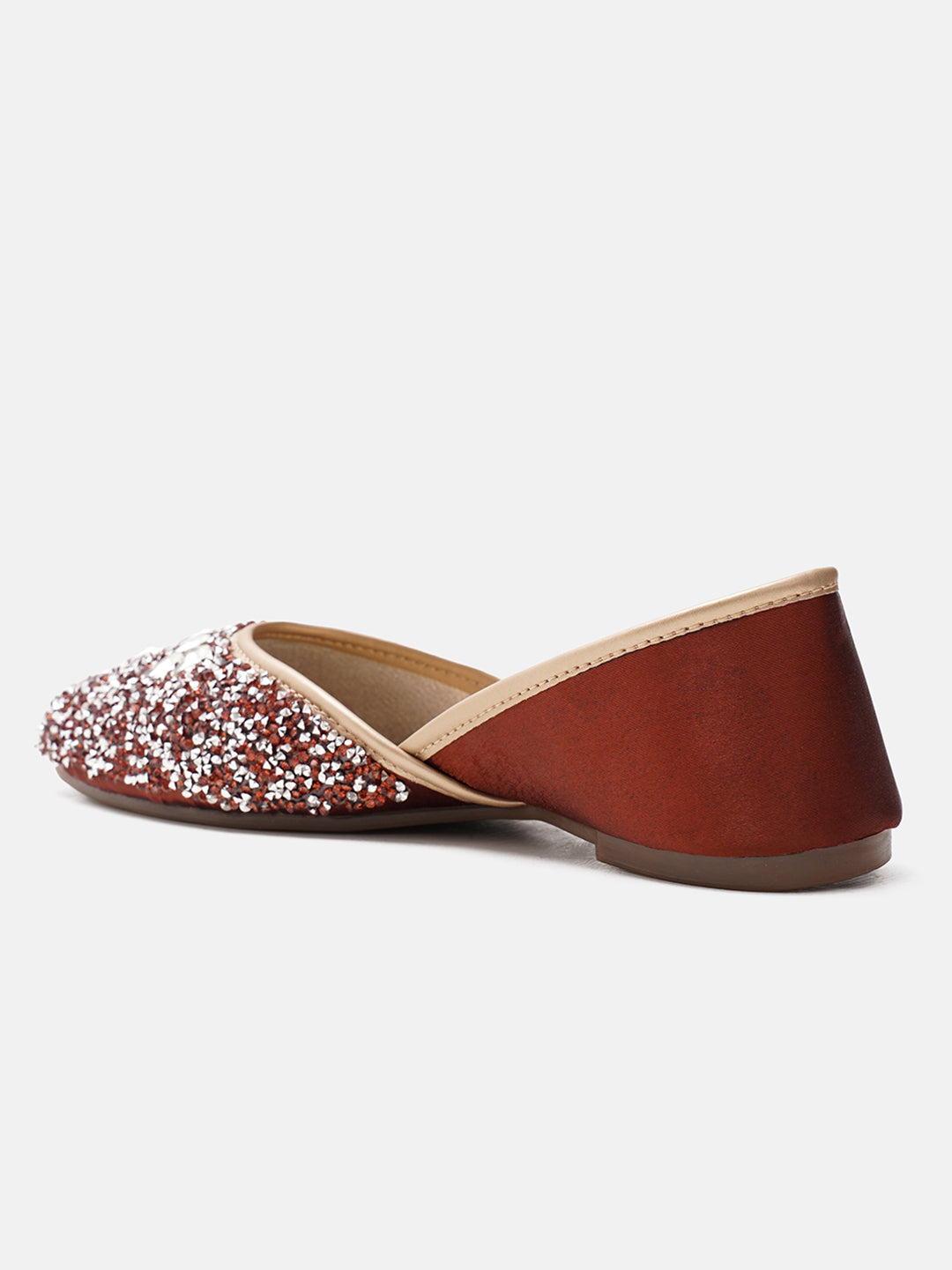 traditional juttis heavily embellished with sequins and large stone details in a floral pattern at the toe
 Copper
