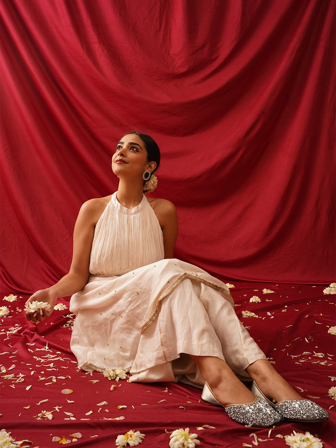 traditional juttis heavily embellished with sequins and large stone details in a floral pattern at the toe
 White