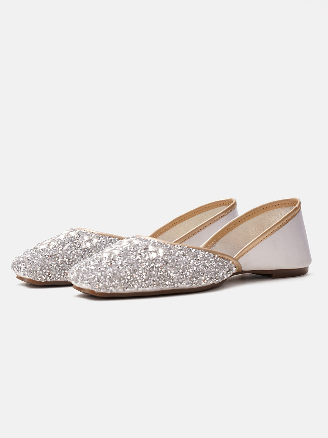 traditional juttis heavily embellished with sequins and large stone details in a floral pattern at the toe
 White