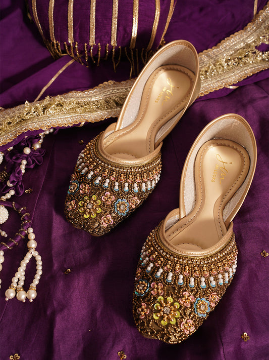 traditional juttis with intricate floral embroidery and detailed beadwork on the upper
 Green