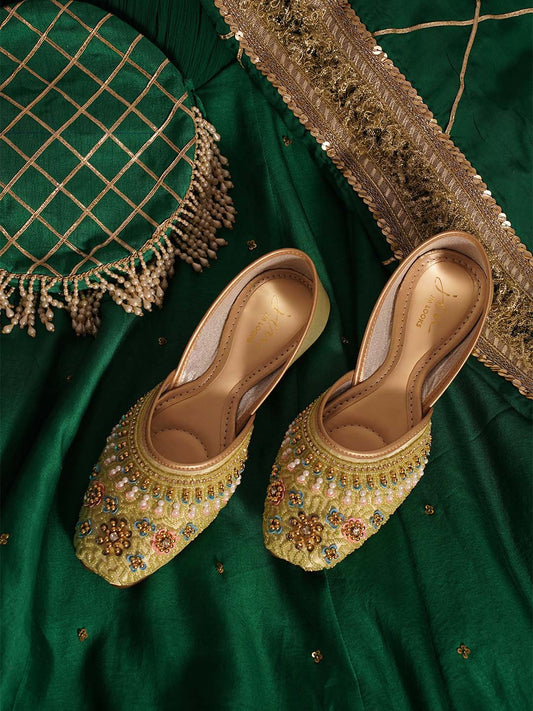 traditional juttis with intricate floral embroidery and detailed beadwork on the upper
 Pista