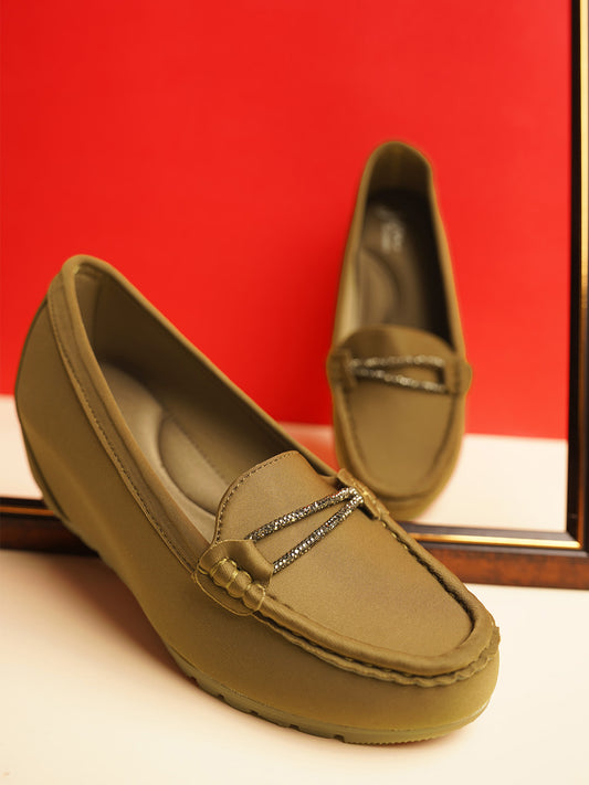 loafers with a subtle wedge heel and an embellished buckle detail on the vamp
 Olive