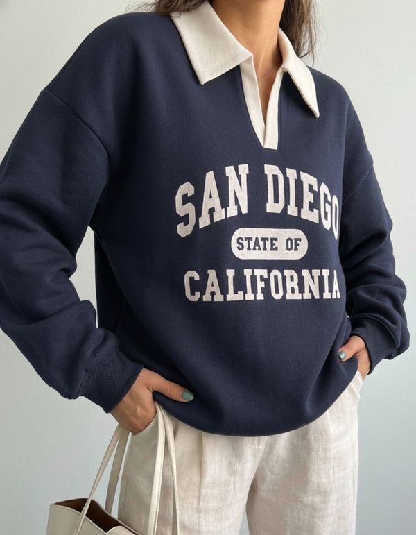 Collared sweatshirt for women in blue with contrast white polo collar and San Diego varsity