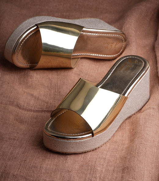 Wedge platform sliders with golden mirror strap, open toe, and textured glittery sole for women.
