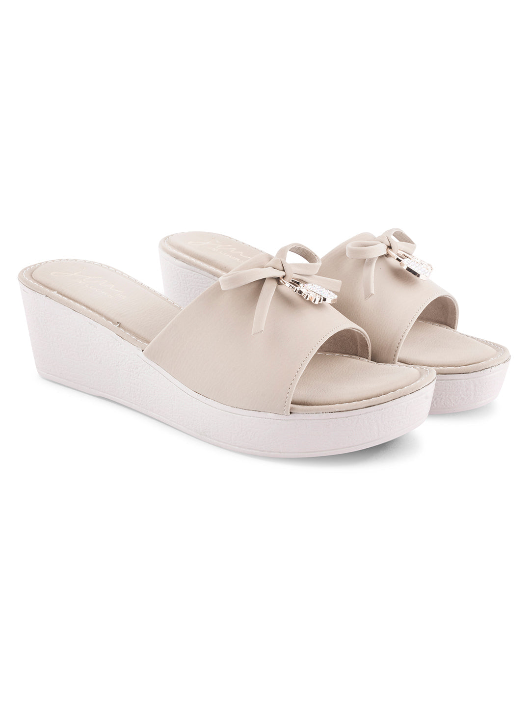 Jm Looks wedge slides with a decorative bow on the strap
 Cream