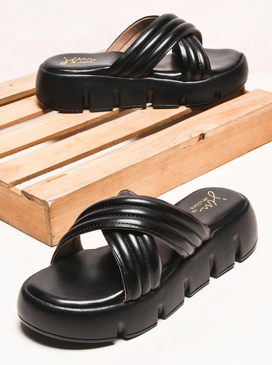 women's platform slides with wide, padded crisscross straps and a chunky lug sole
 Black