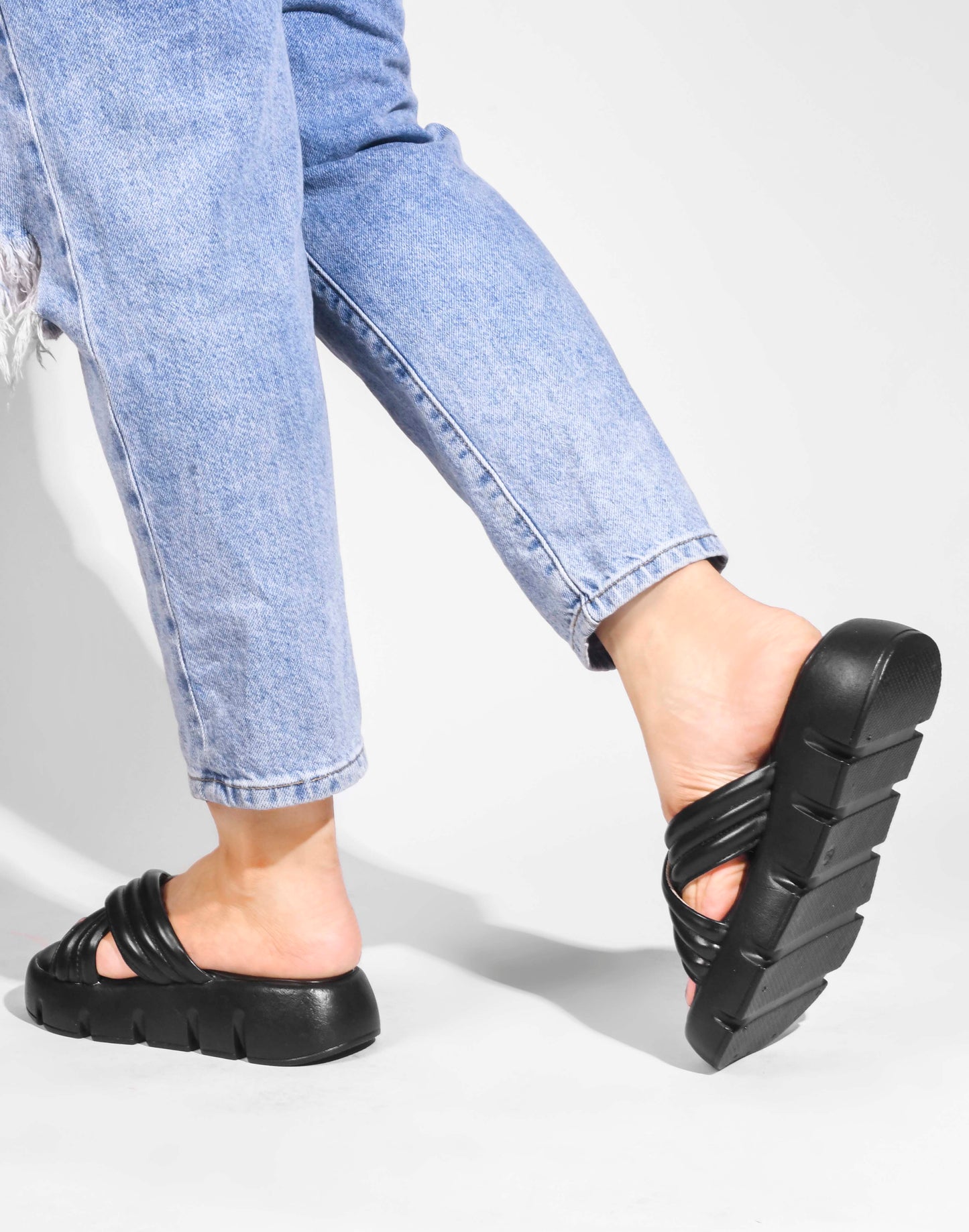 women's platform slides with wide, padded crisscross straps and a chunky lug sole
 Black