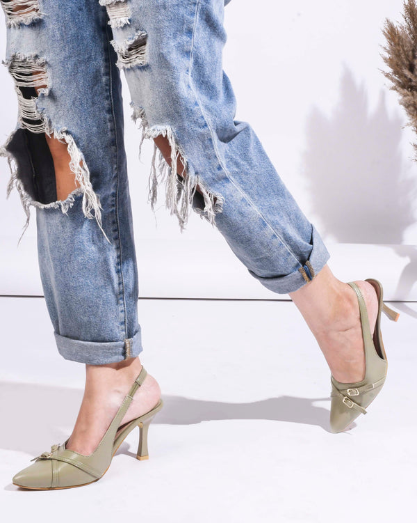 A pointed-toe slingback heel with strap and buckle details on the vamp and an adjustable strap
 Green