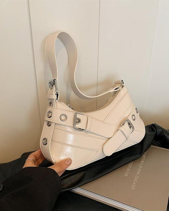 Hobo shoulder bag in white featuring double buckle straps, silver hardware, and an adjustable strap design.