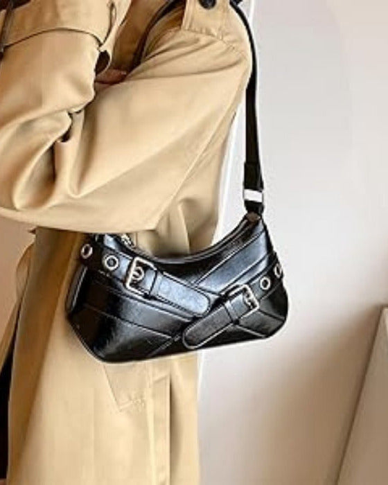 Hobo shoulder bag in black featuring double buckle straps, silver hardware, and an adjustable strap design.