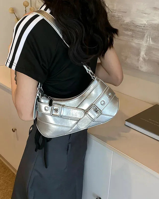Hobo shoulder bag in silver featuring double buckle straps, silver hardware, and an adjustable strap design.