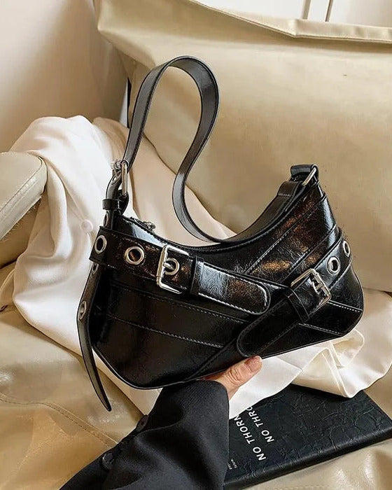 Hobo shoulder bag in black featuring double buckle straps, silver hardware, and an adjustable strap design.