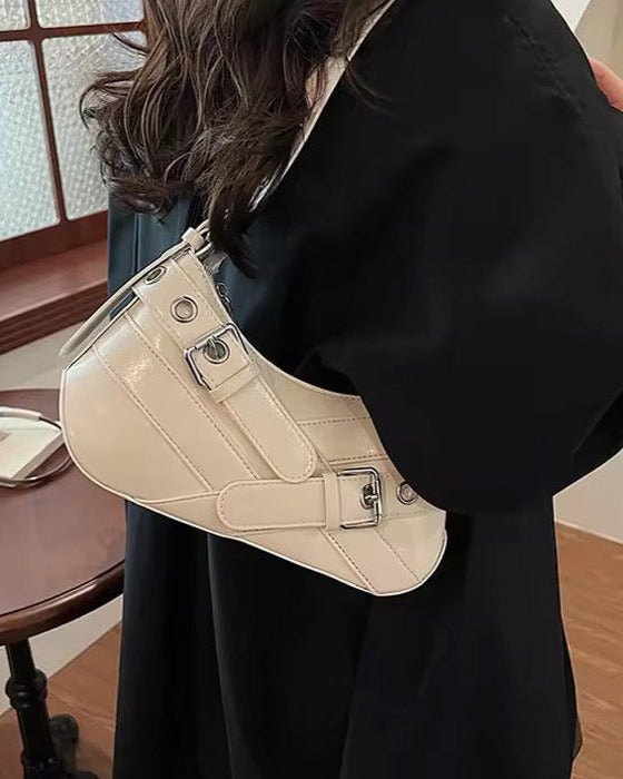 Hobo shoulder bag in white featuring double buckle straps, silver hardware, and an adjustable strap design.