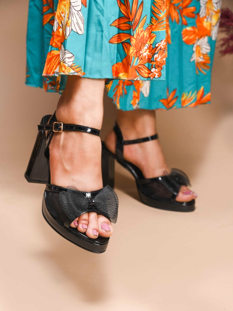 Jm Looks platform heels with a sheer bow detail on the front strap and an ankle strap
 Black
