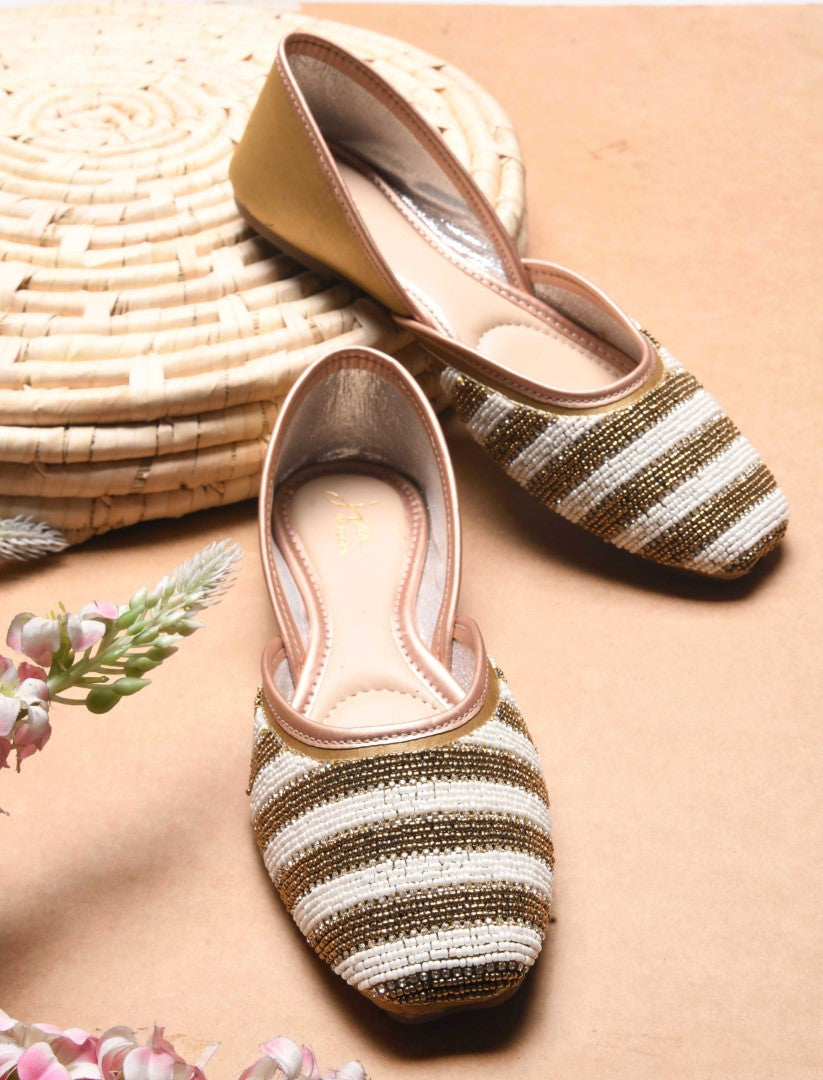 Jm Looks juttis featuring a black and white striped beaded pattern
 Copper