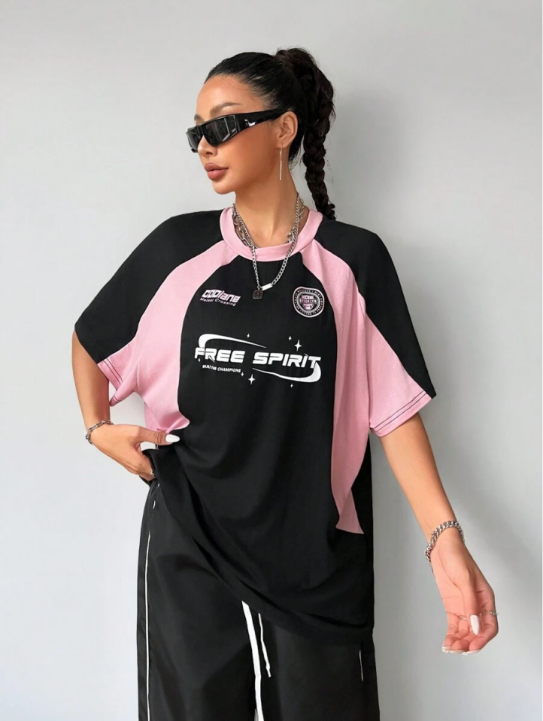 Oversized streetwear graphic t-shirt in black with pink side panels and bold typography front back design