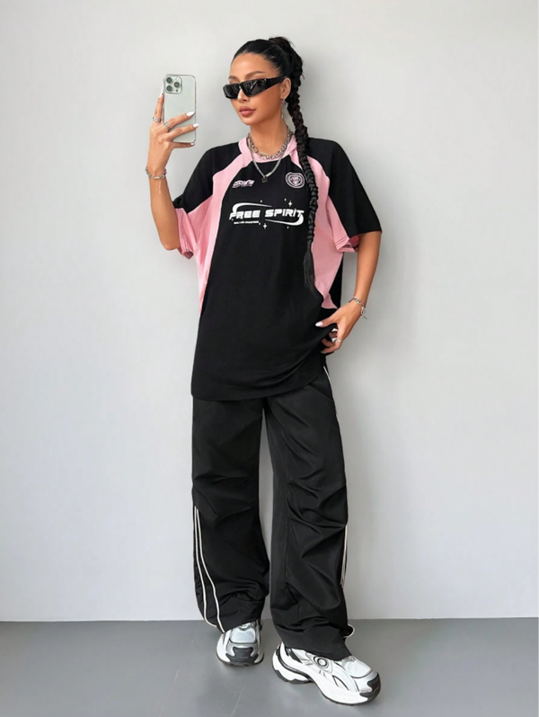 Oversized streetwear graphic t-shirt in black with pink side panels and bold typography front back design