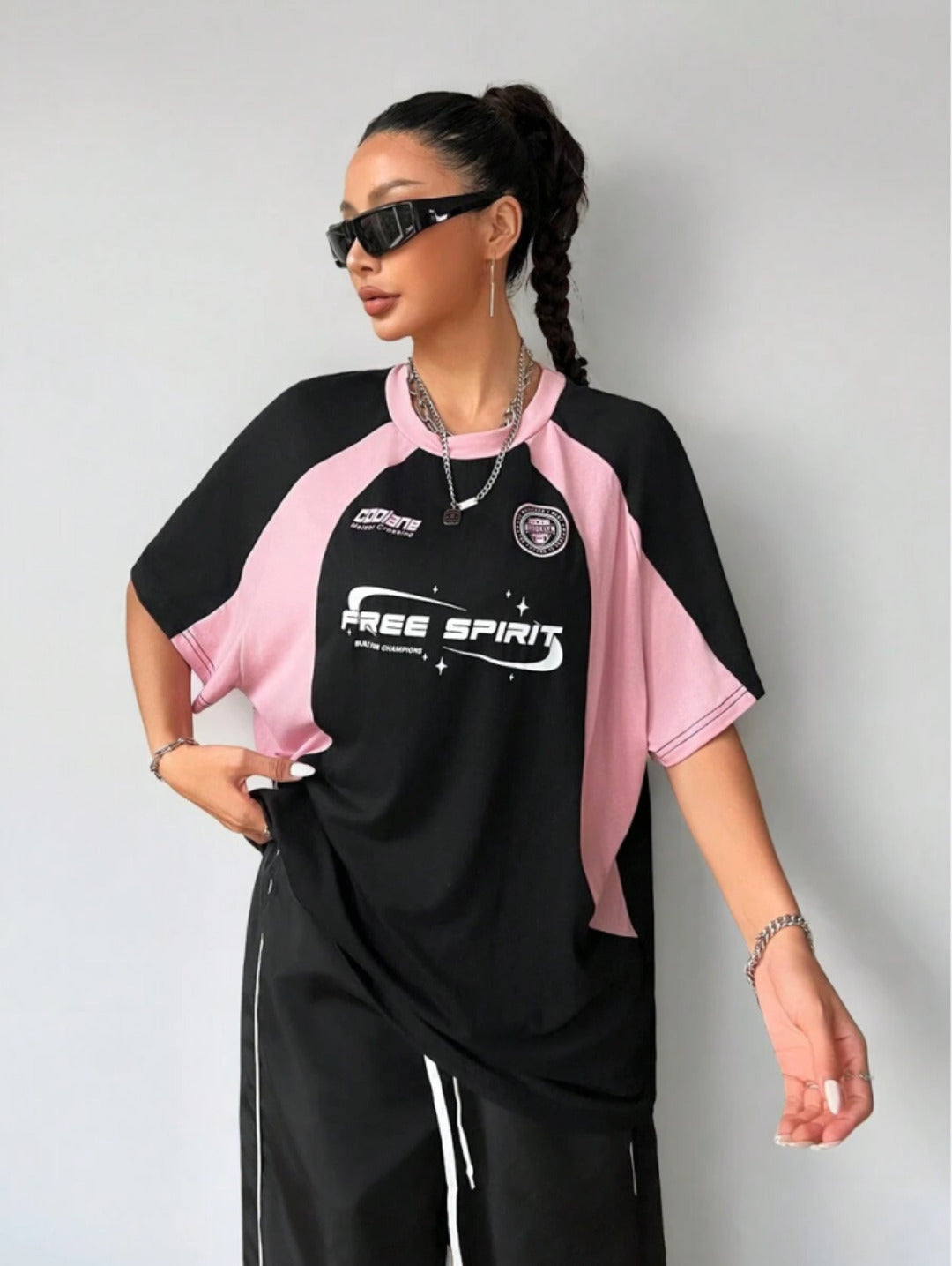 Oversized colorblock t-shirt for women in black and pink with graphic text print and drop shoulders