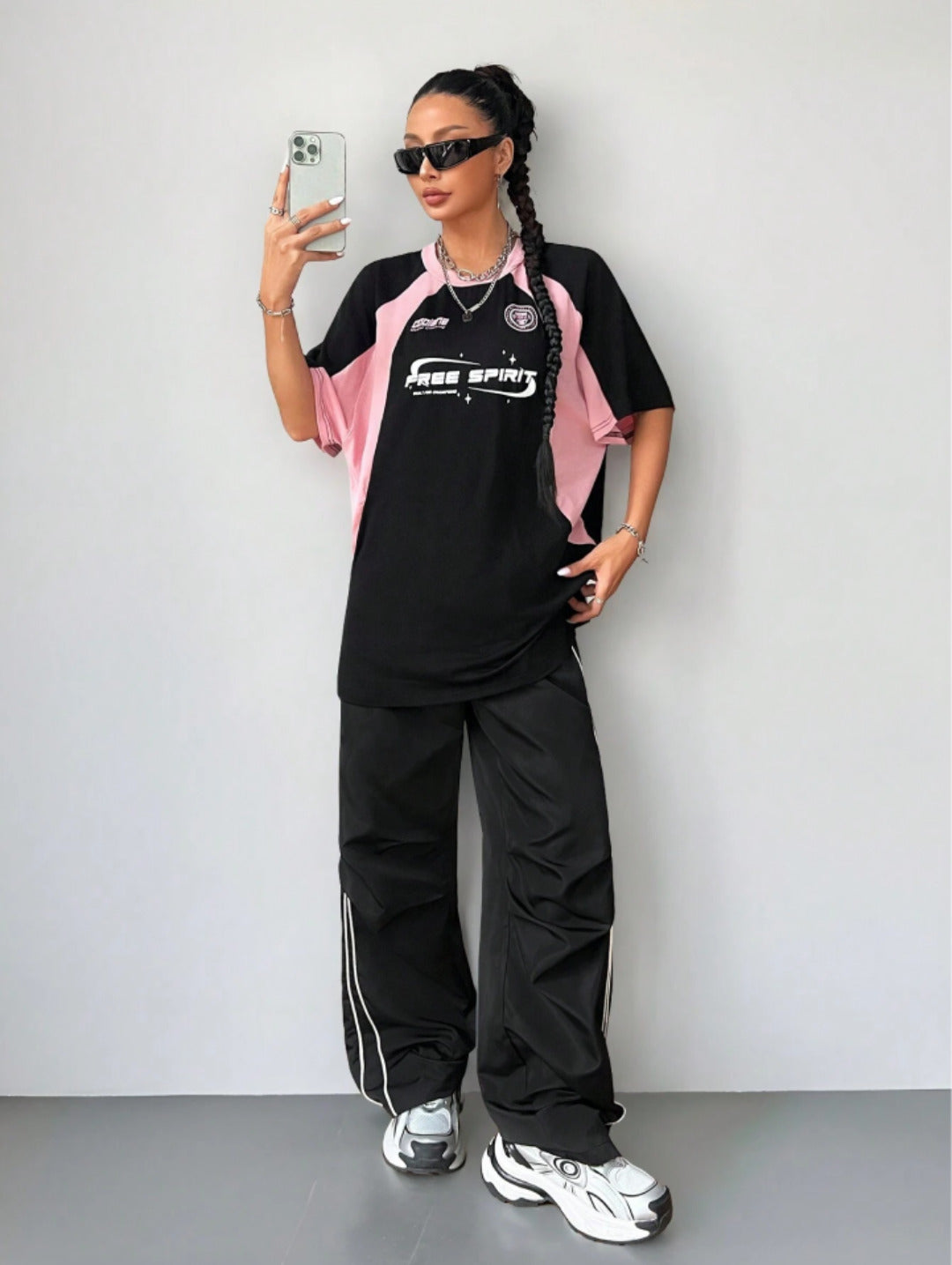 Oversized colorblock t-shirt for women in black and pink with graphic text print and drop shoulders