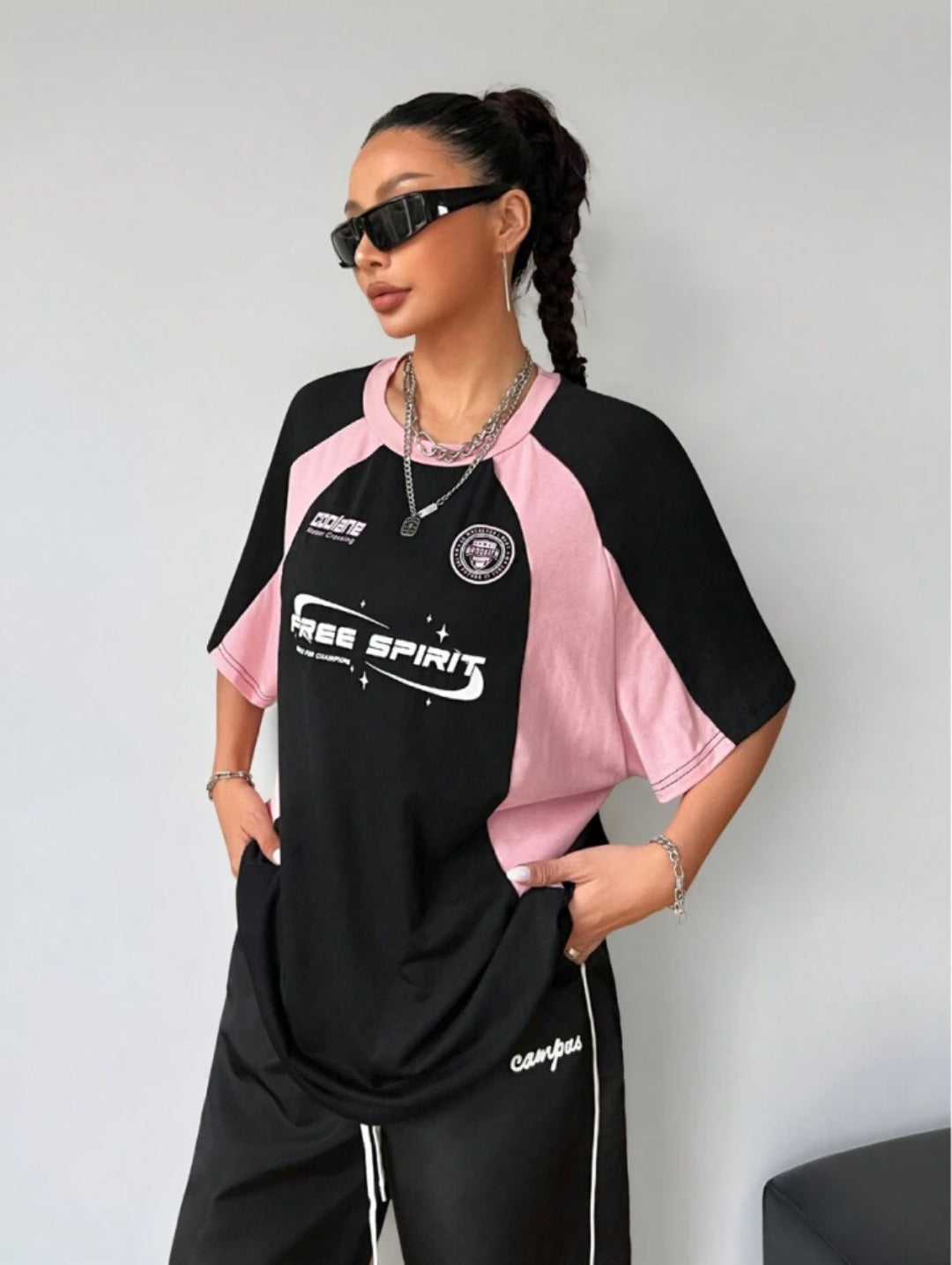 Oversized colorblock t-shirt for women in black and pink with graphic text print and drop shoulders