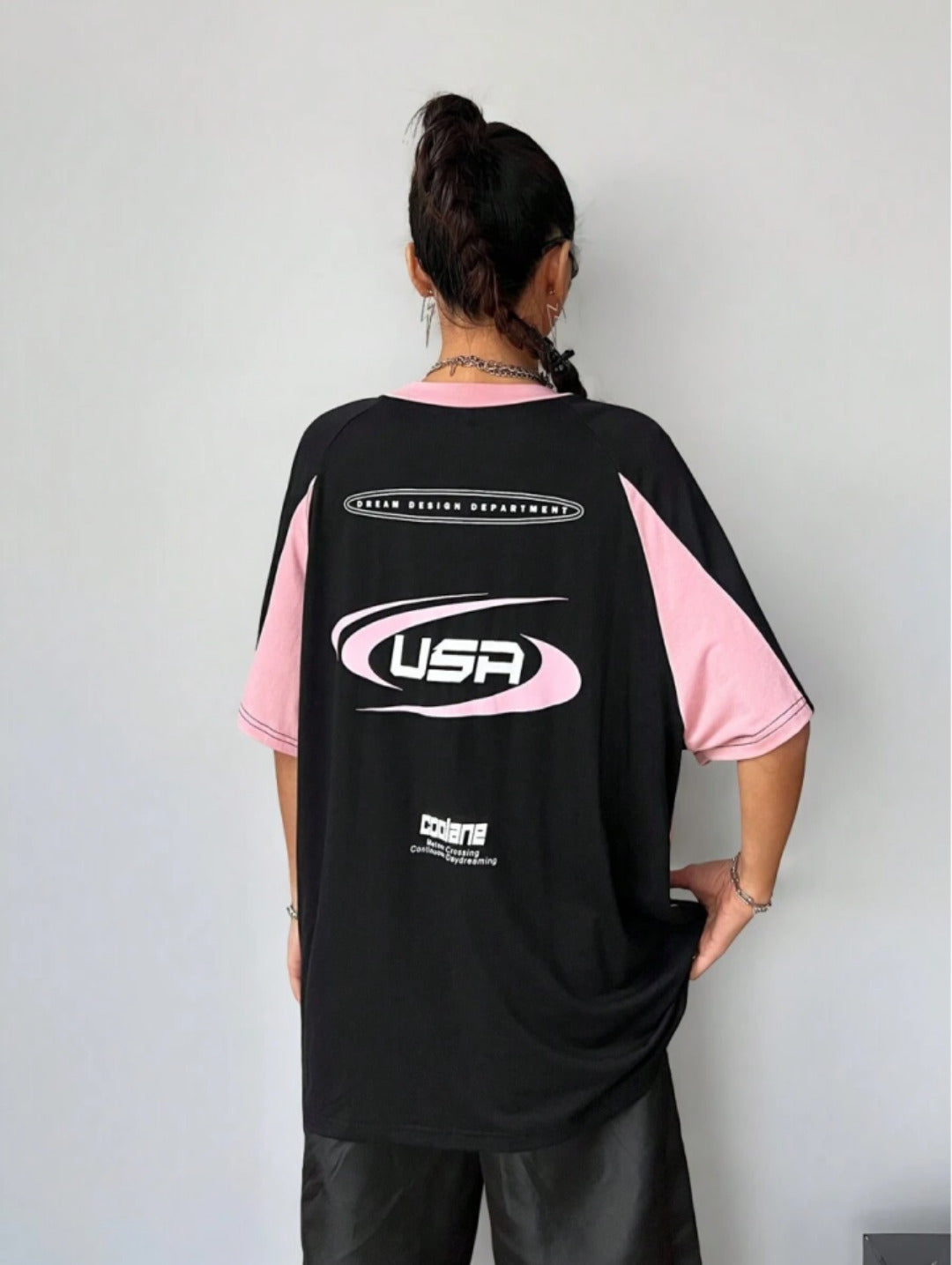 Oversized colorblock t-shirt for women in black and pink with graphic text print and drop shoulders