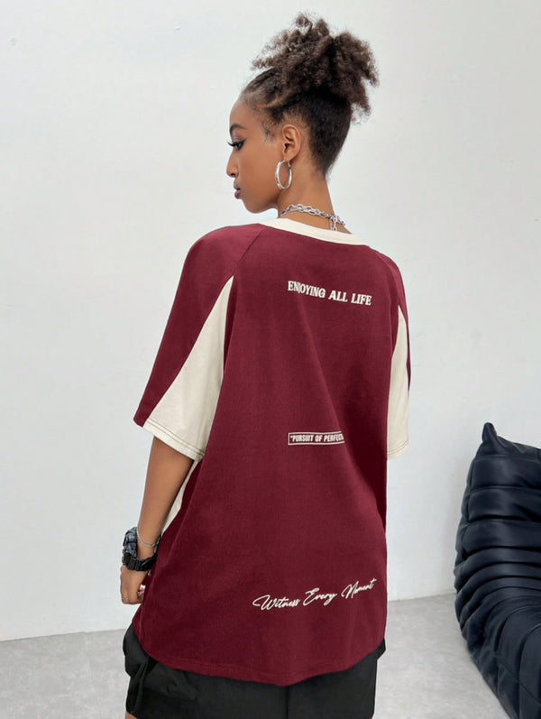 Oversized colorblock t-shirt for women in maroon and cream with graphic text print and drop shoulders