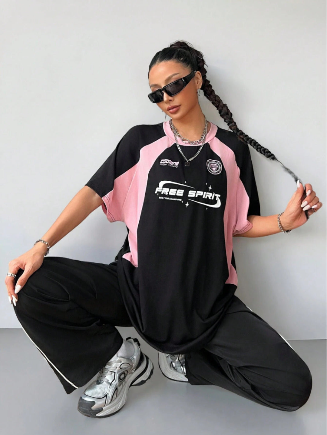 Oversized colorblock t-shirt for women in black and pink with graphic text print and drop shoulders
