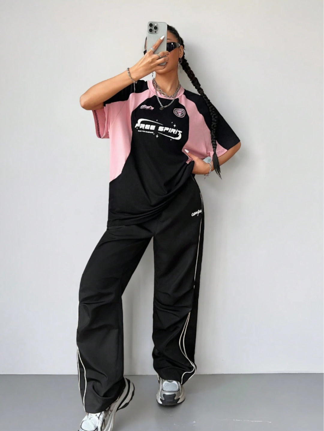 Oversized colorblock t-shirt for women in black and pink with graphic text print and drop shoulders