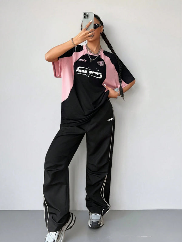 Oversized colorblock t-shirt for women in black and pink with graphic text print and drop shoulders