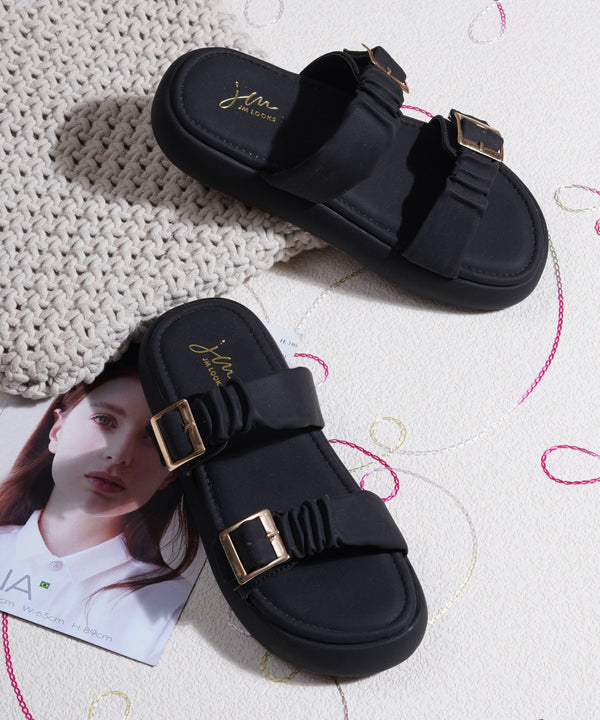 Platform sandals for women in black with ruched dual straps, gold buckles and thick cushioned footbed