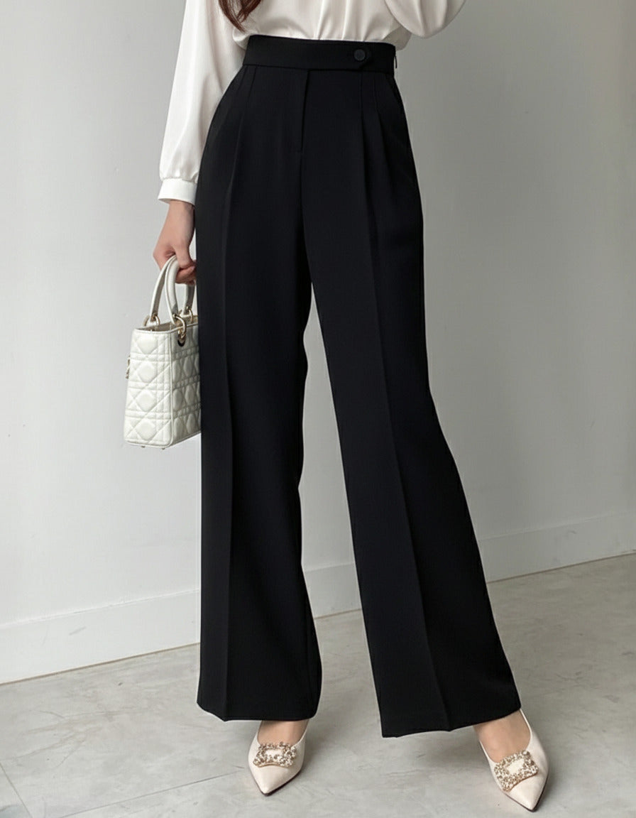 Pleated wide leg flowy trousers in black, high waist button closure, styled with white satin blouse
