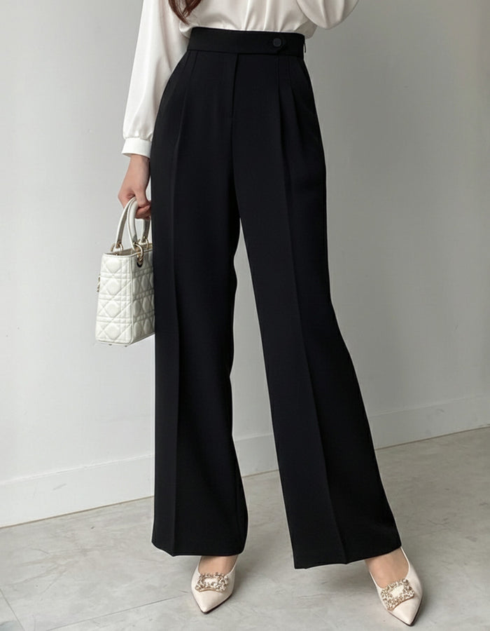 Pleated wide leg flowy trousers in black, high waist button closure, styled with white satin blouse