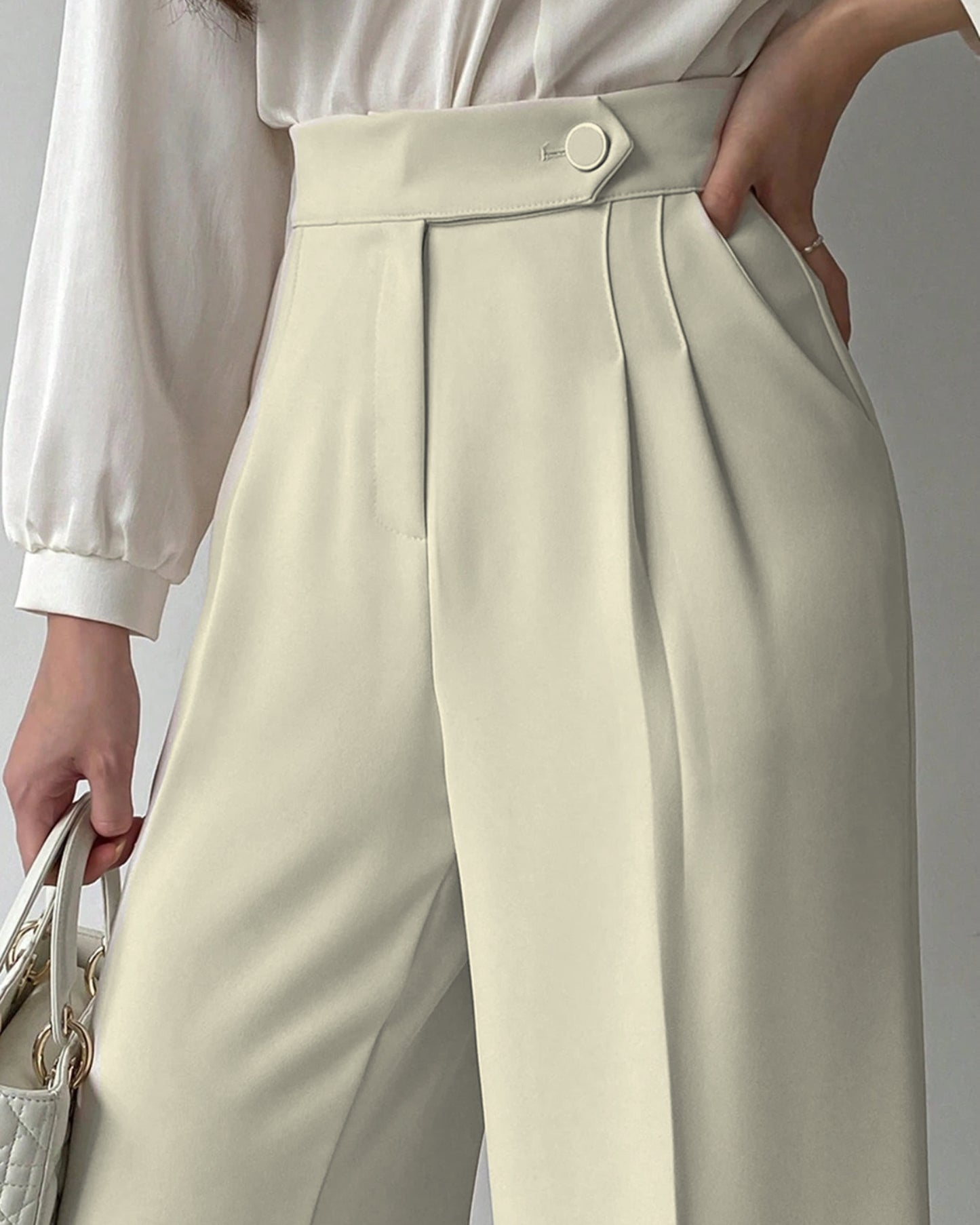 Pleated wide leg flowy trousers in cream, high waist button closure, styled with white satin blouse