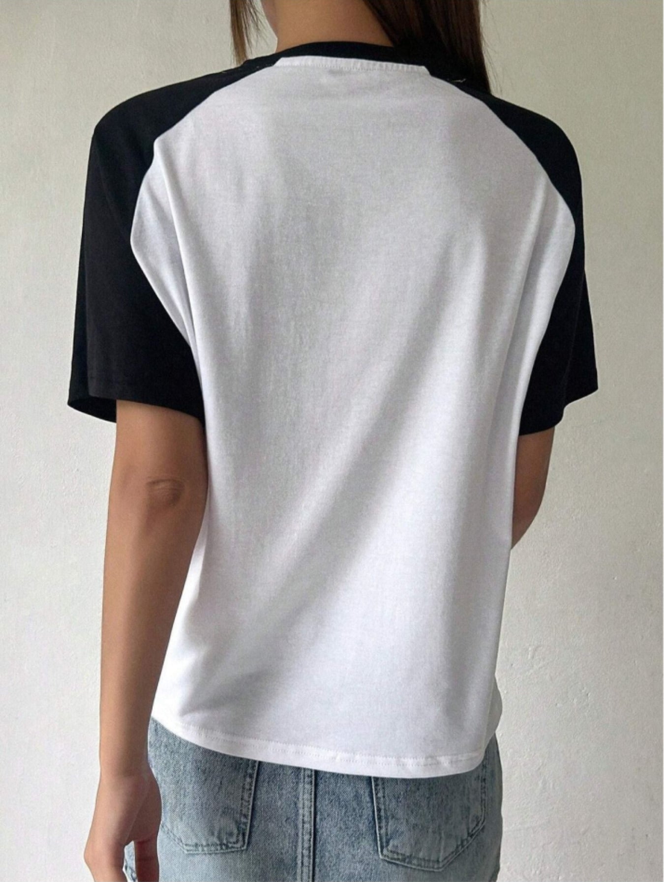 Raglan t-shirt for women in white with black half sleeves, front star print and round neck.