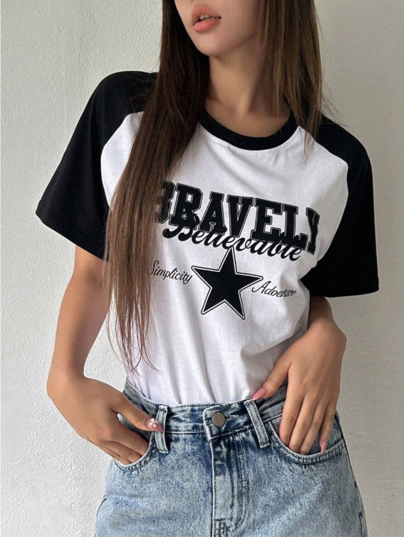 Raglan t-shirt for women in white with black half sleeves, front star print and round neck.