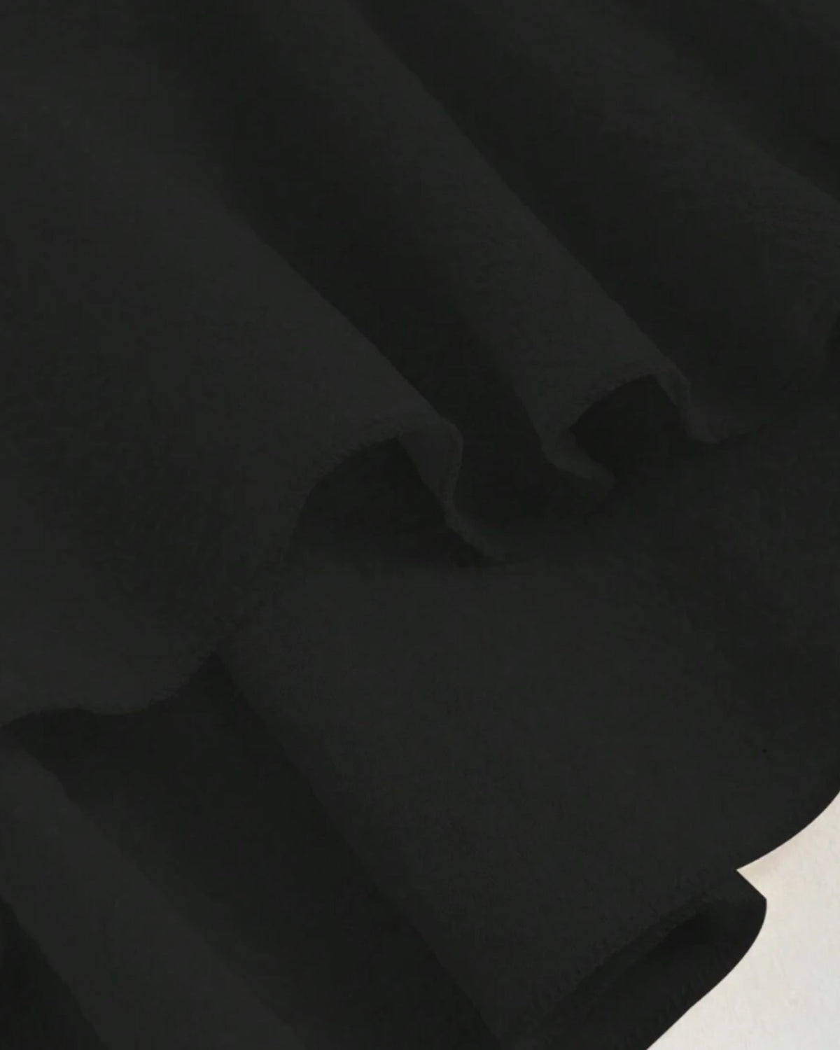 Ruffle trim blouse with sweetheart neckline in black, featuring smocked bodice, flutter sleeves, flared peplum hem