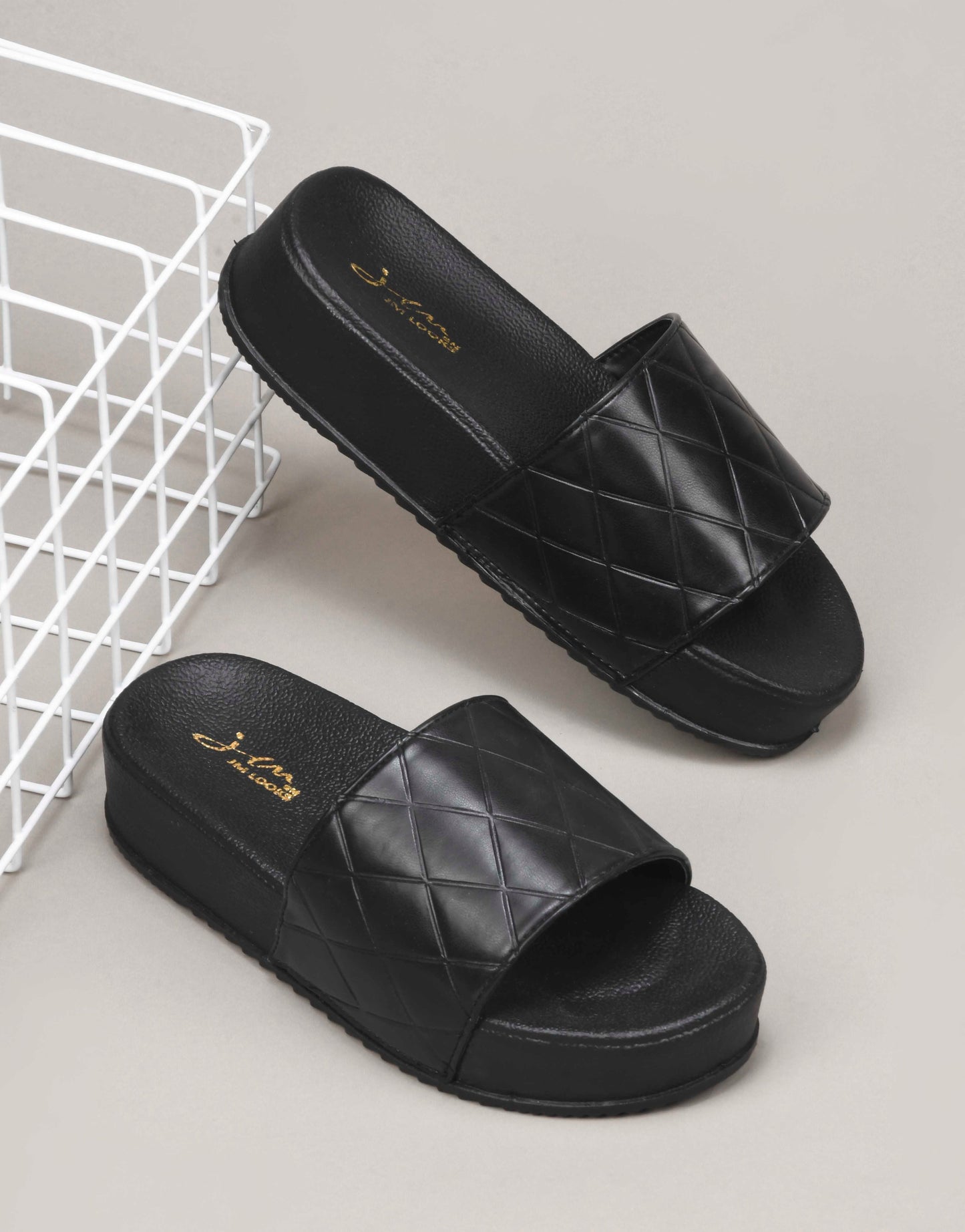 women's platform slides with a quilted upper strap
 Black