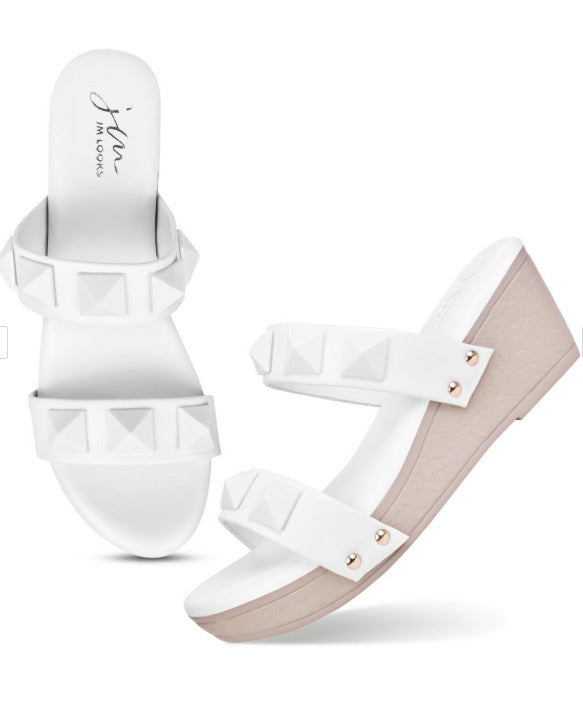 Wedge heels for women featuring white pyramid studded dual straps and blush pink platform slip-on sole