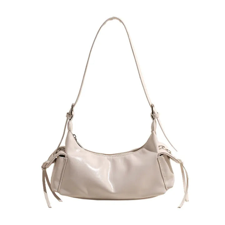 White glossy hobo shoulder bag with adjustable strap, side lace-up pockets, and sleek zip closure design