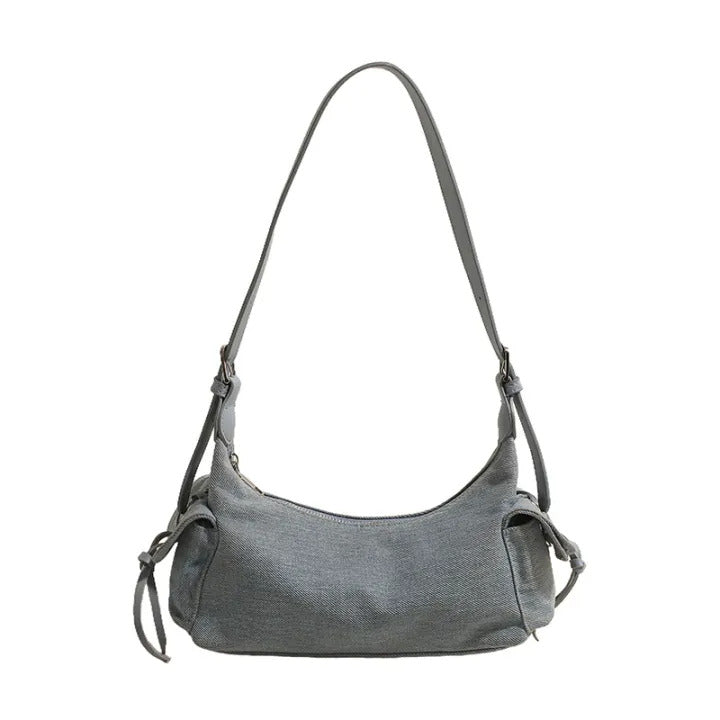 Blue glossy hobo shoulder bag with adjustable strap, side lace-up pockets, and sleek zip closure design