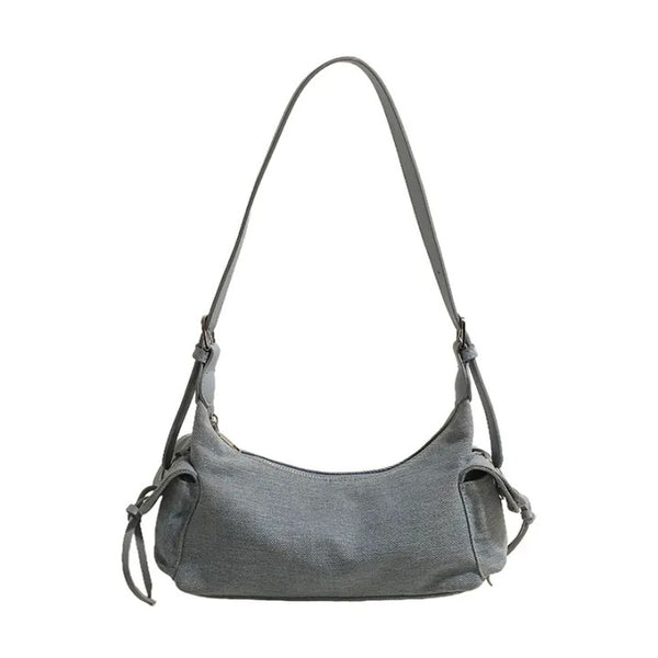 Blue glossy hobo shoulder bag with adjustable strap, side lace-up pockets, and sleek zip closure design
